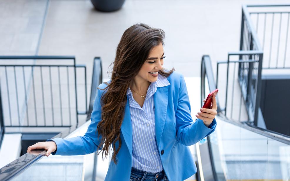 Young Lebanese woman confidently using a mobile phone — embracing digital wallets for secure and effortless money management.